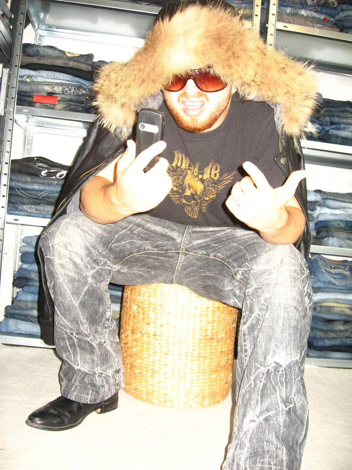 Lenny in a fur hood on the phone